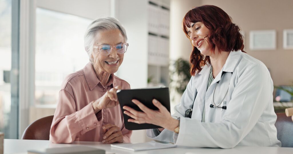 Doctor assisting patient with tablet for healthcare payment solutions in Georgia 
